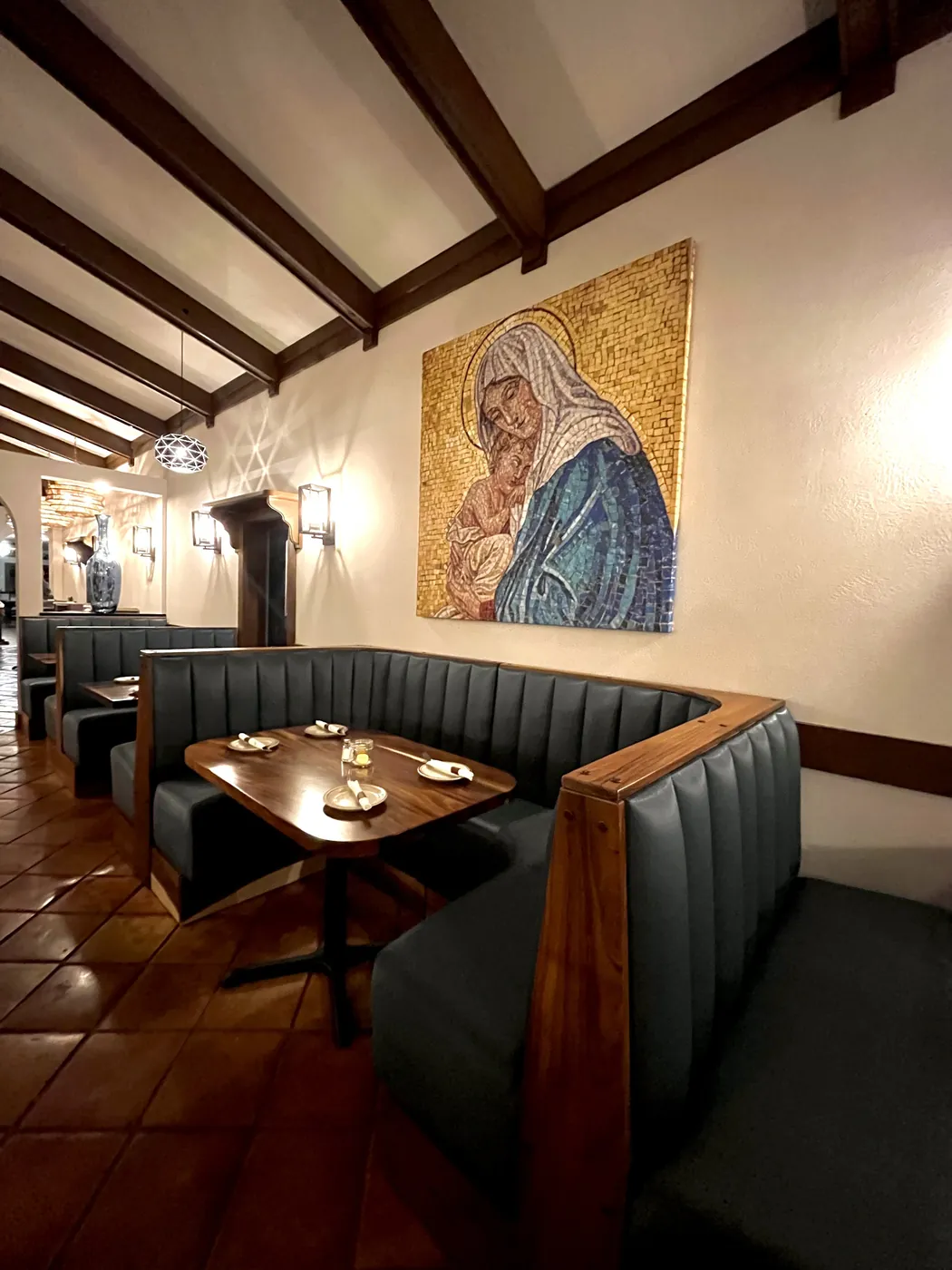 Booth seating and artwork inside El Molino